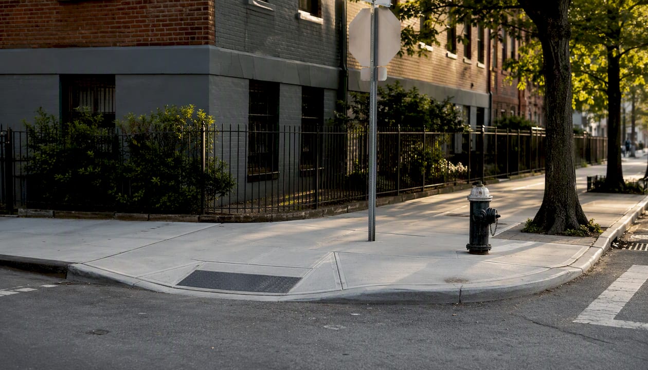NYC street corner with curb cut sidewalk access
