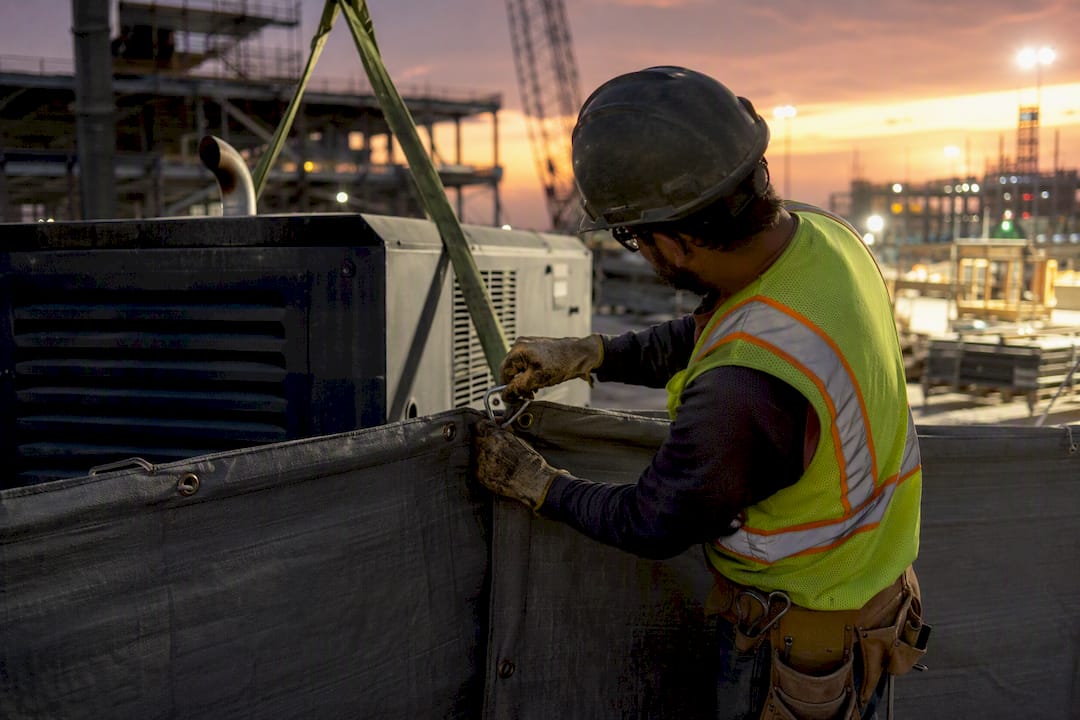 Hands installing temporary sound barrier panel