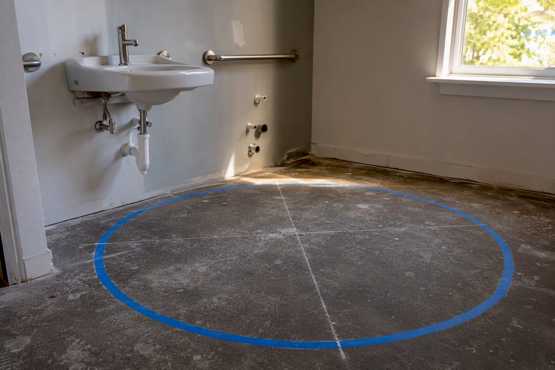 Floor marked for ADA clear turning space in bathroom