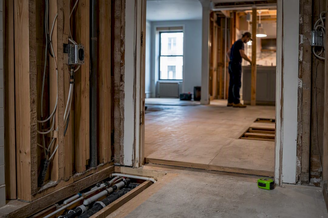 Stripped NYC apartment showing exposed renovation systems