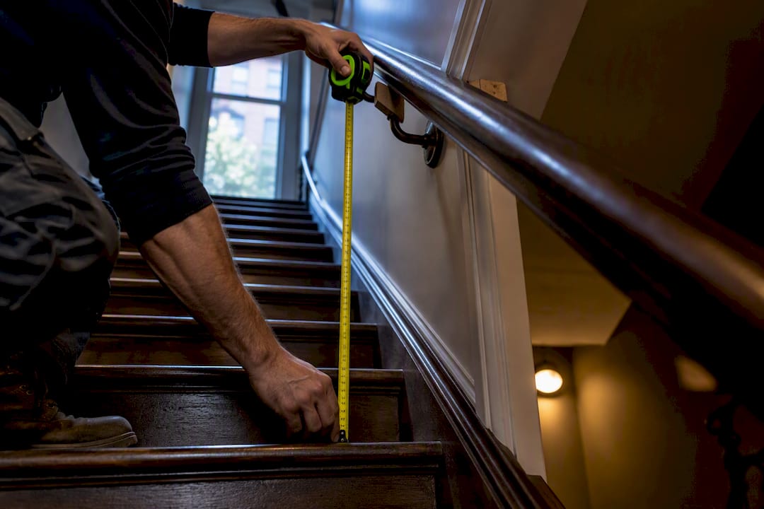 Contractor measuring stair handrail height