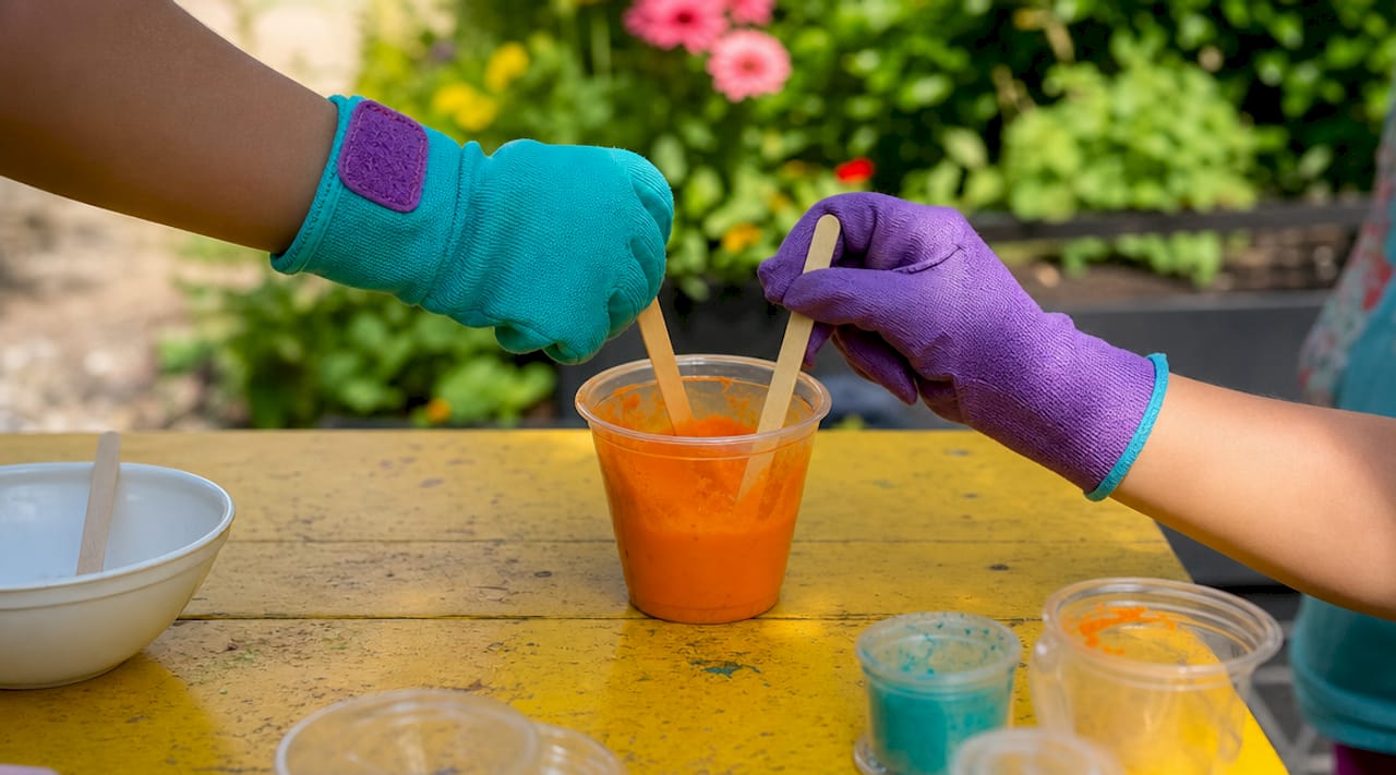 Children’s hands mixing acid-base reaction cup
