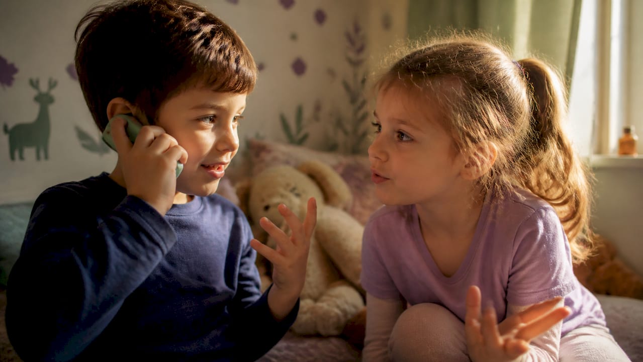 Children role-playing conversation indoors