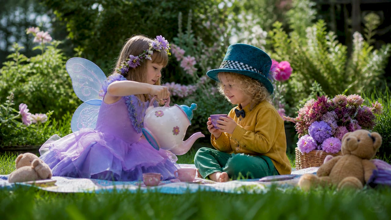 Children in costume having a pretend tea party