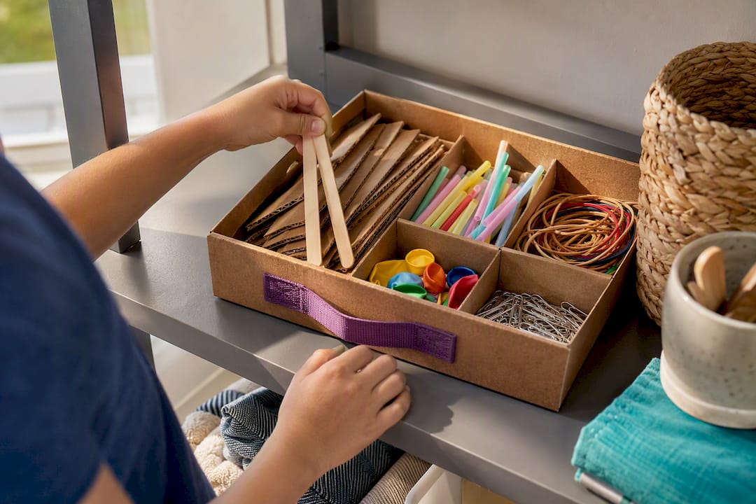 Hands choosing materials from a home engineering bin