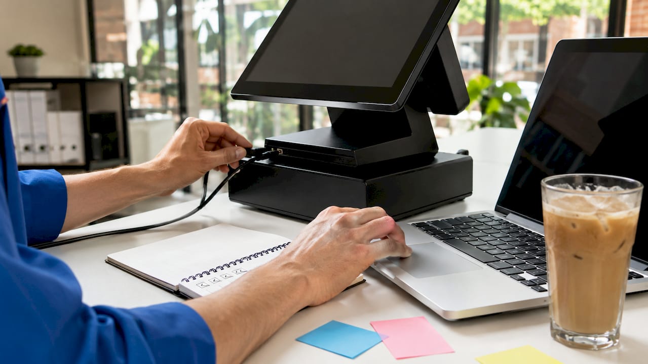 Hands connecting network cable and laptop for EPOS