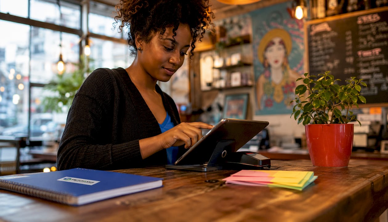 Employee using integrated EPOS and payment devices