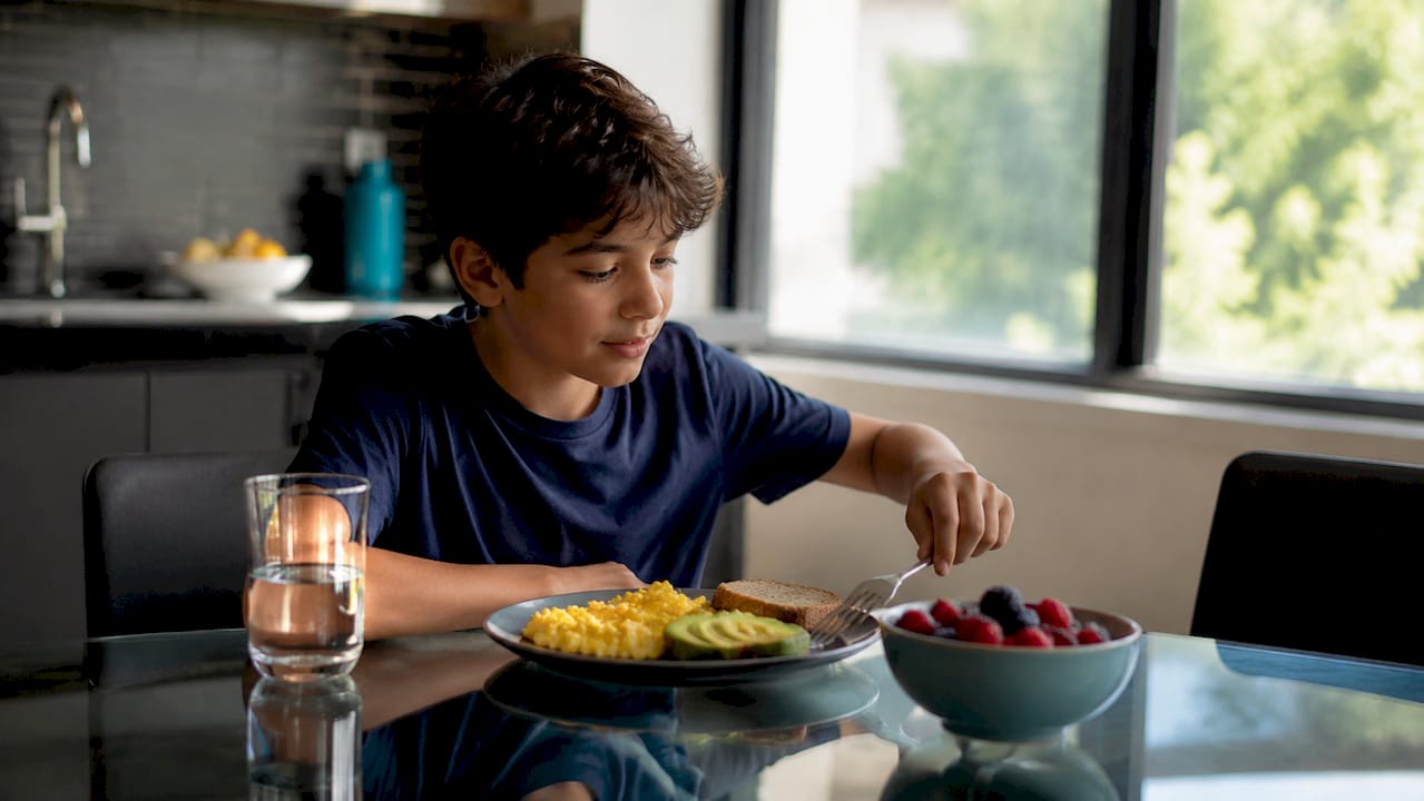 Young boy eating protein-rich breakfast