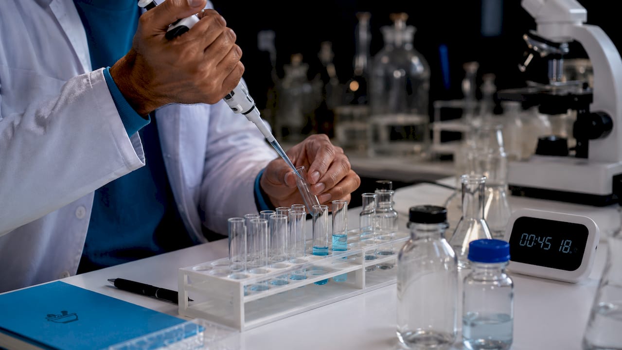 Biochemist pipetting nutrient samples