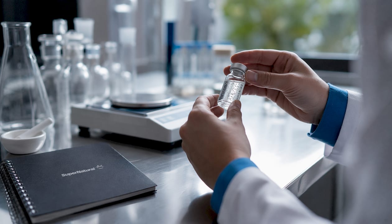 Hands measuring nanoparticle supplement vial accurately