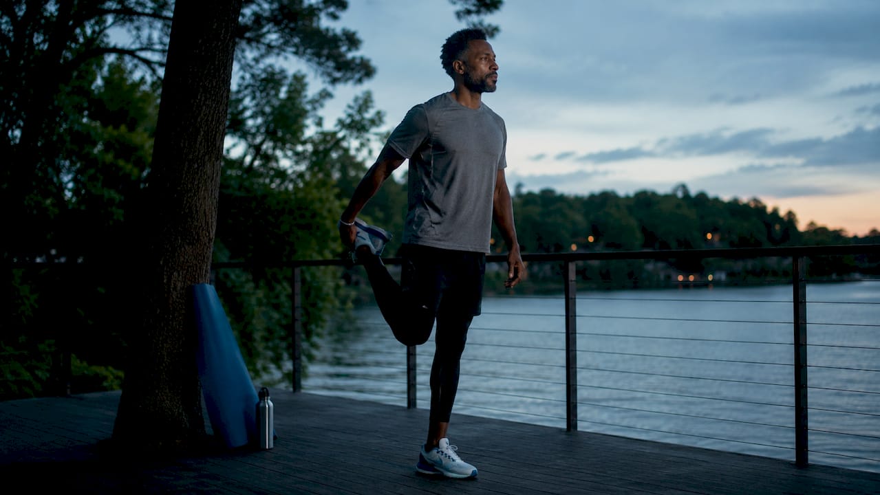 Man stretching outdoors for mental energy
