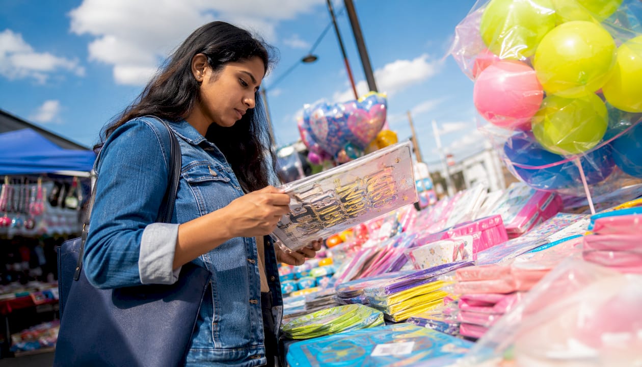 Woman reviewing party kits at round table