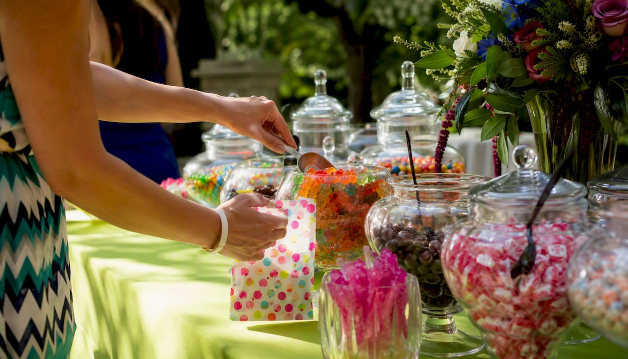 Serving bulk candy from jars on buffet middle zone