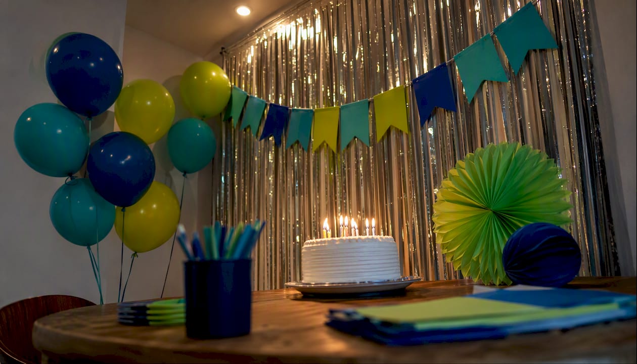 Candle moment birthday setup with banner and balloons