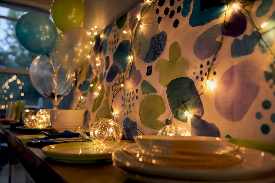 Warm string lights on party backdrop
