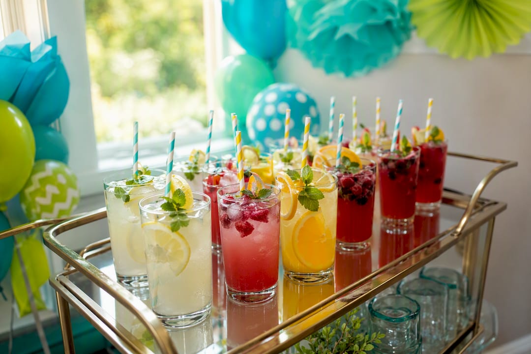 Colorful mocktail drinks on baby shower bar