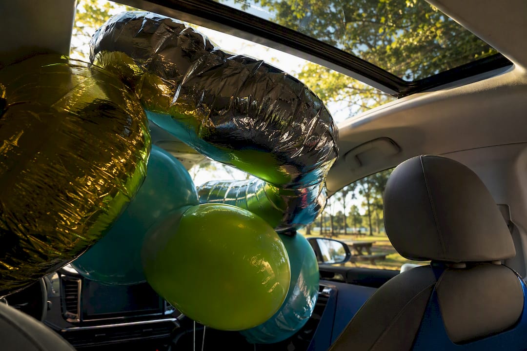 Helium balloons expanded inside parked car