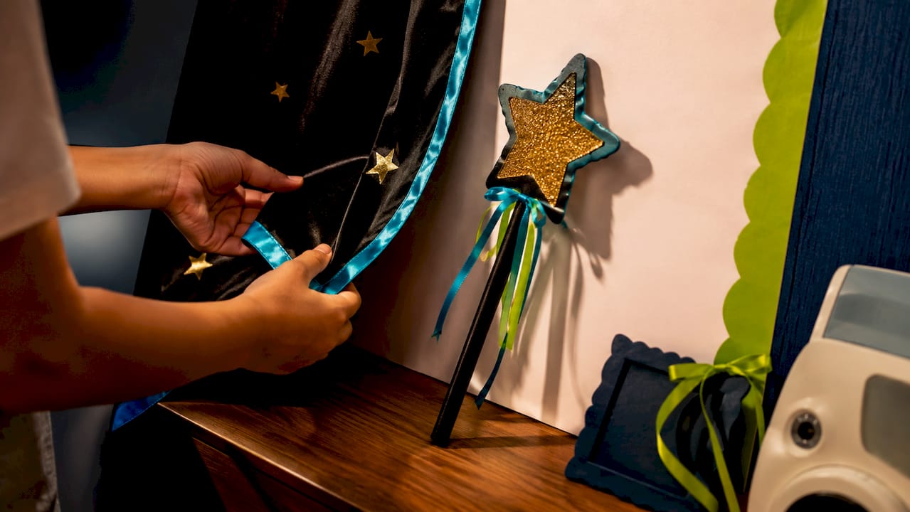 Magic photo booth props beside backdrop