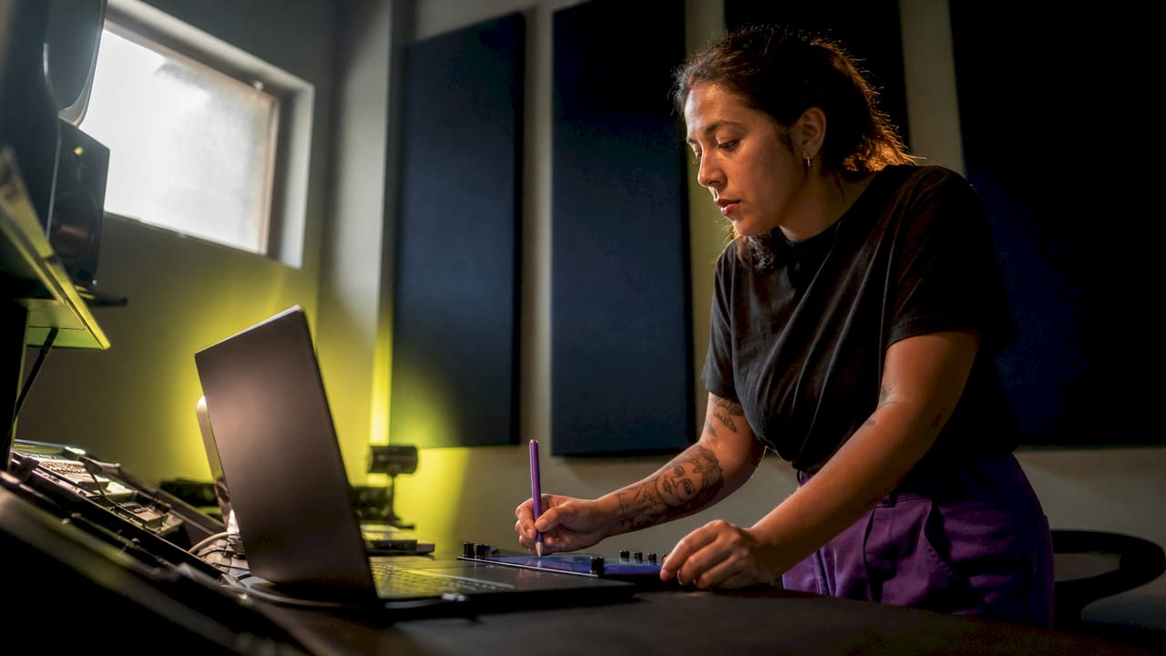 Audio engineer reviewing mixing plugins in studio