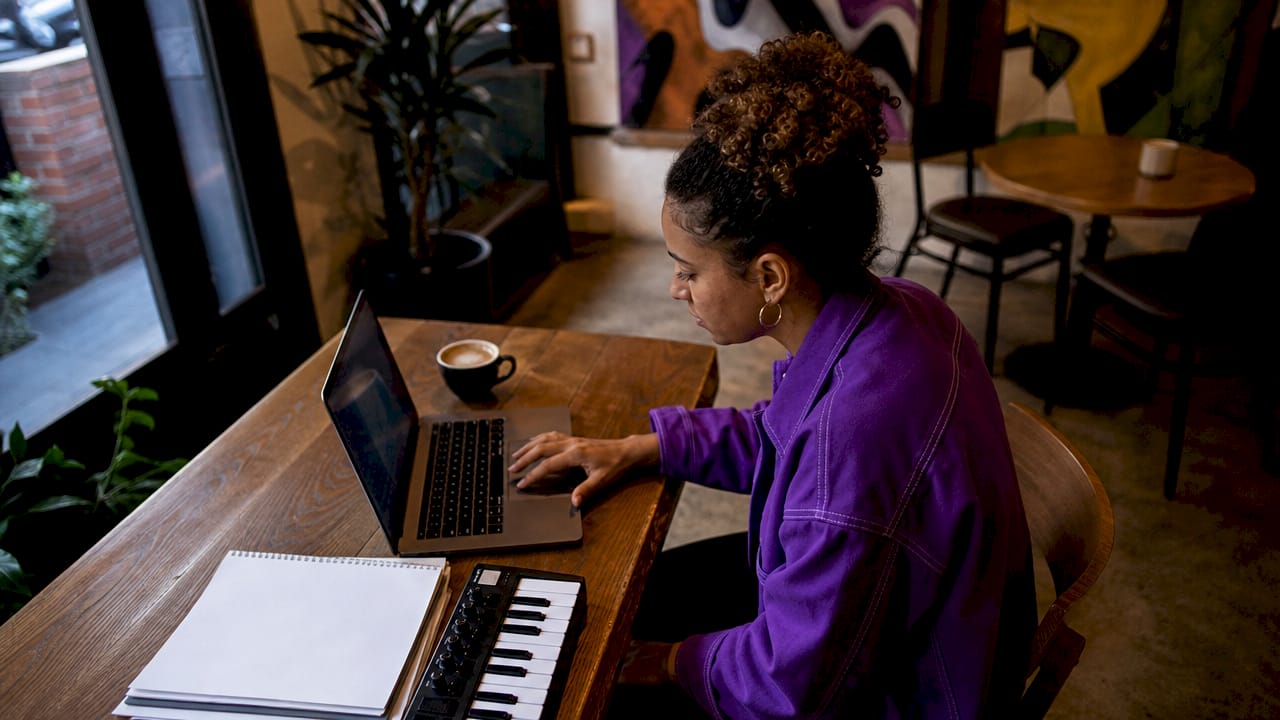 Music producer adjusting plugins in home studio