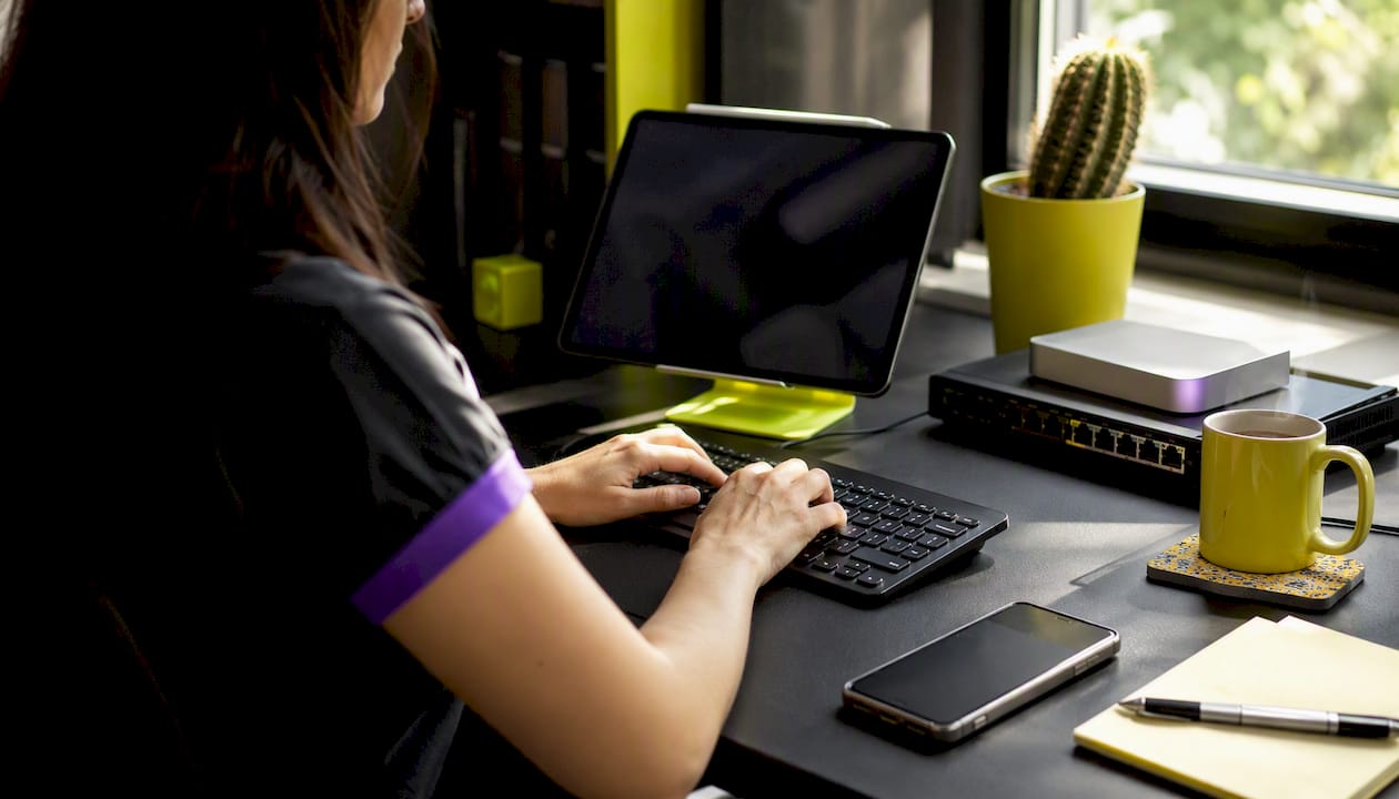 Hands managing VPS and domain setup on desk