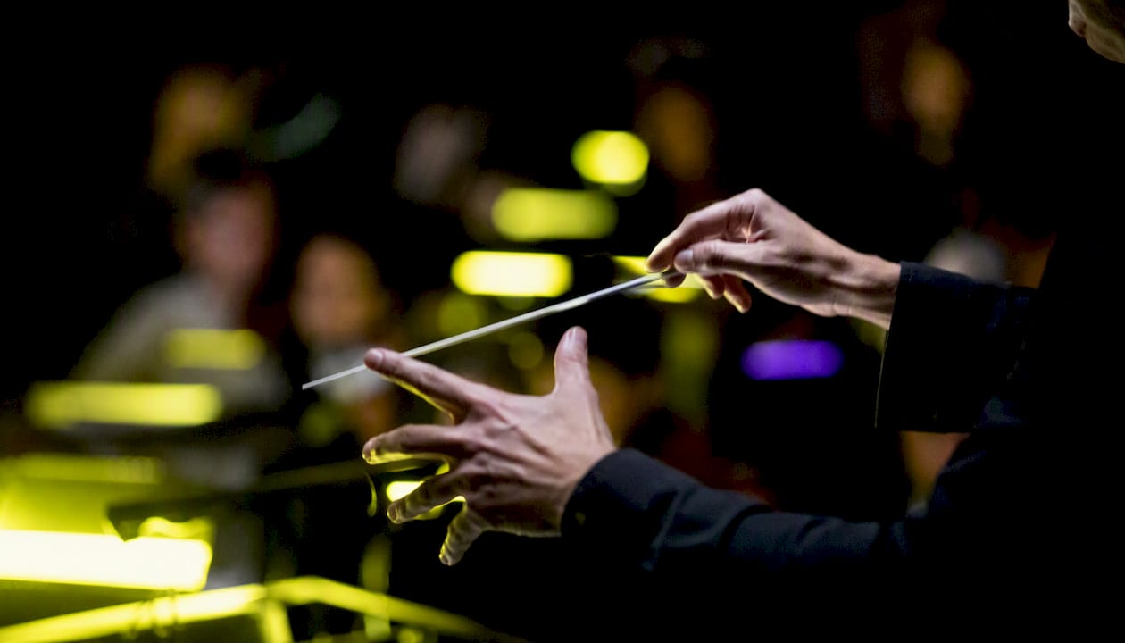 Conductor&rsquo;s hands conducting orchestra remotely