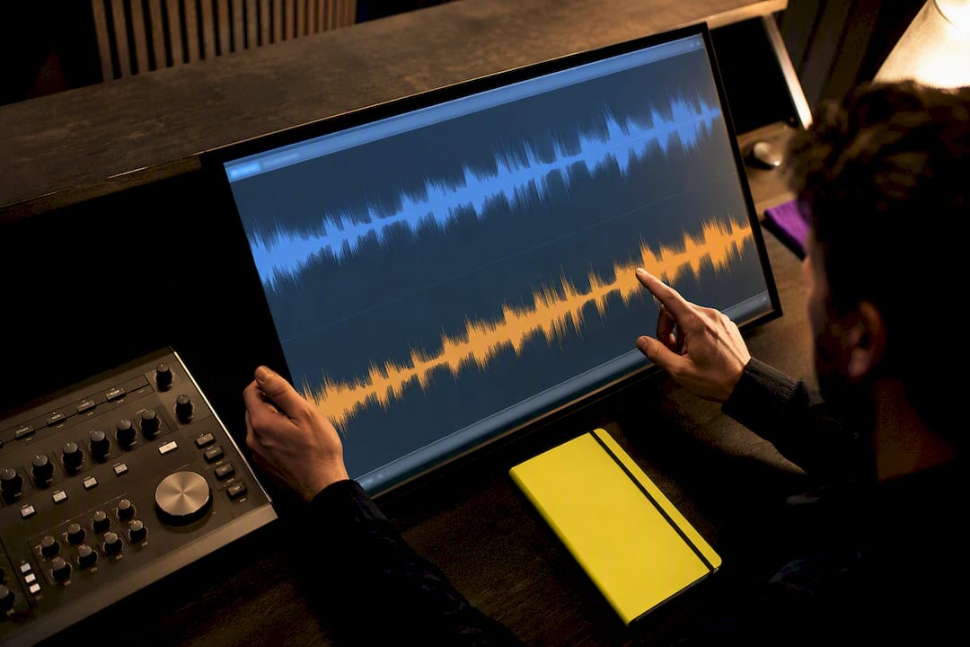 Engineer comparing converted audio waveforms