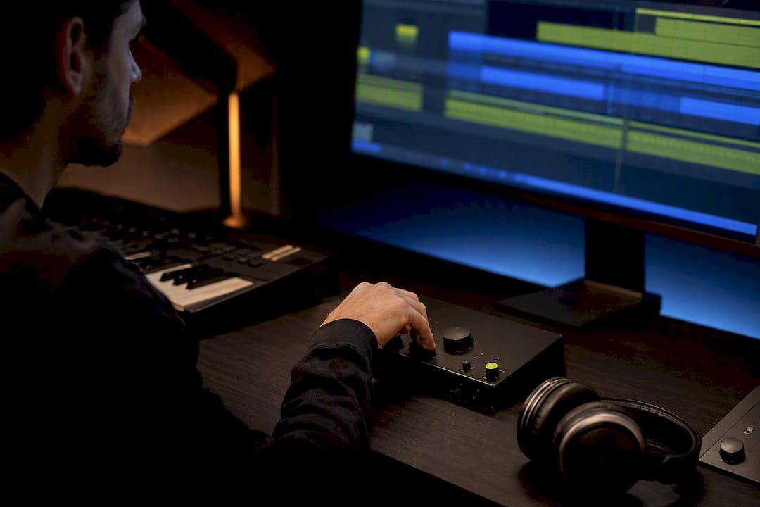 Producer adjusting audio driver settings in studio