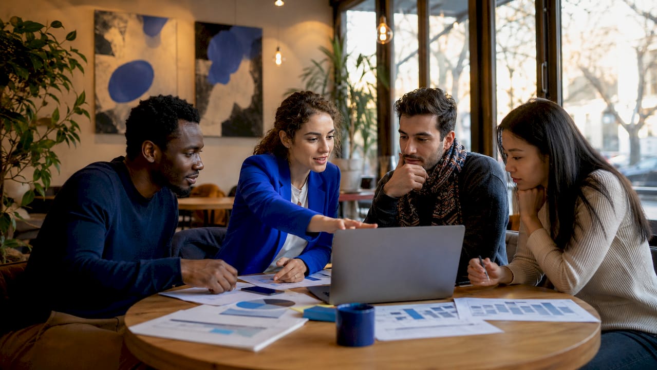 Team planning crowdfunding campaign in co-working space