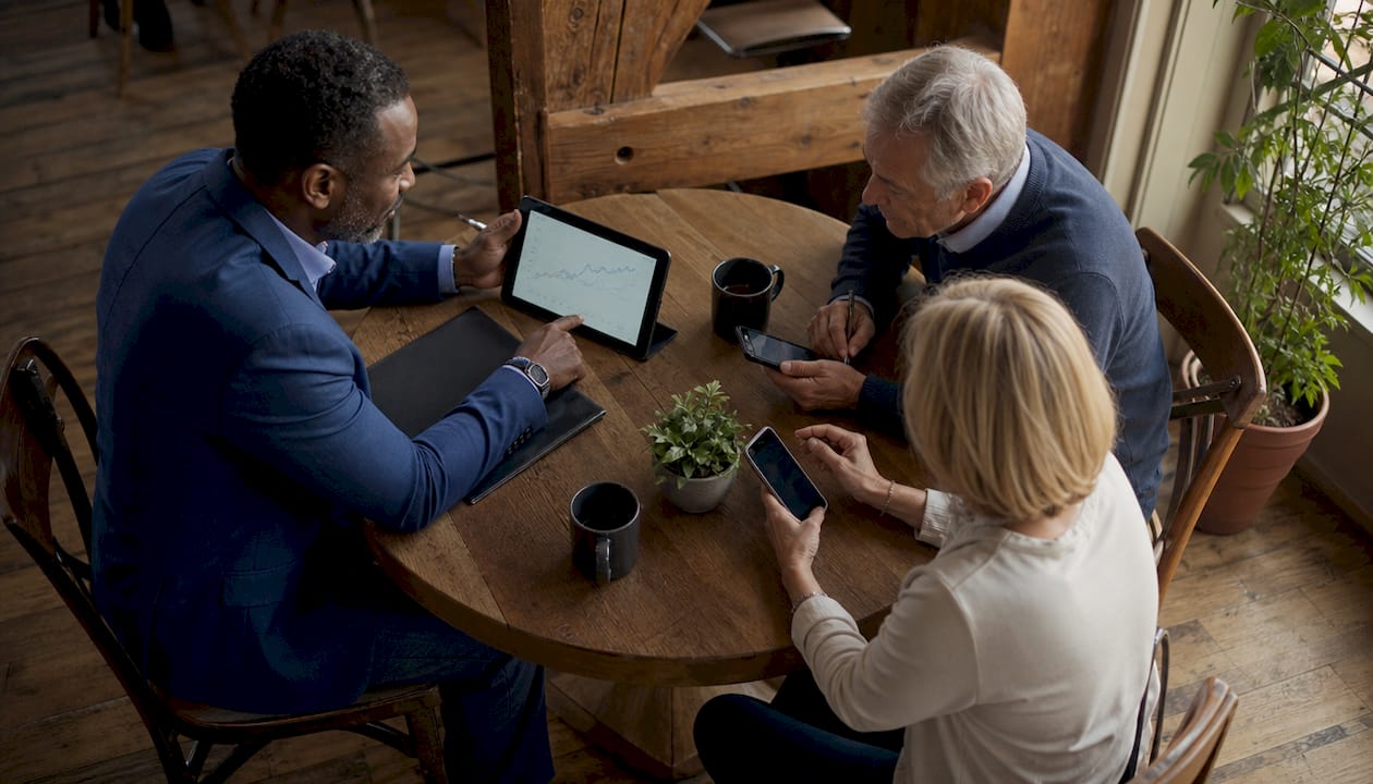 Financial advisor consulting couple on portfolio audit