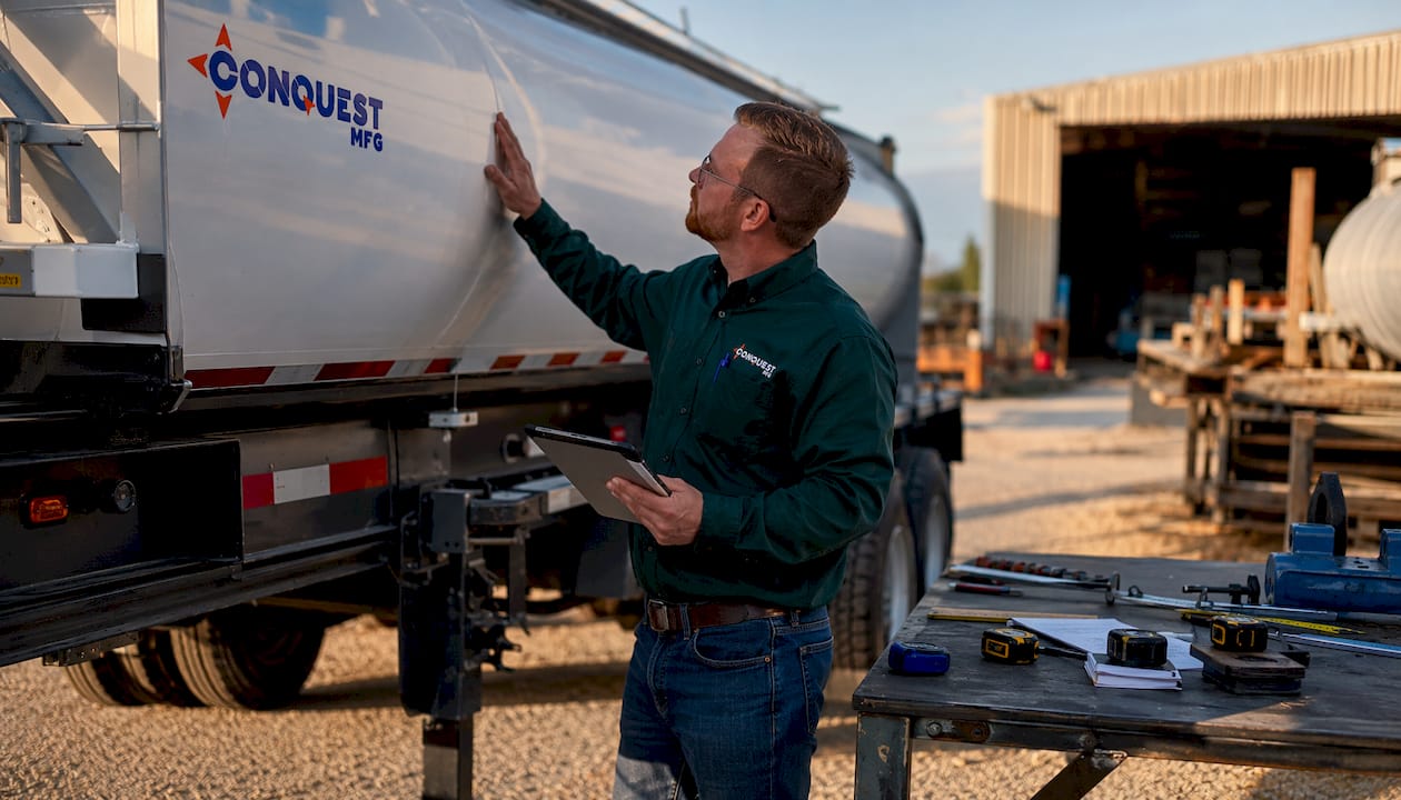 Engineer inspecting half round trailer outdoors