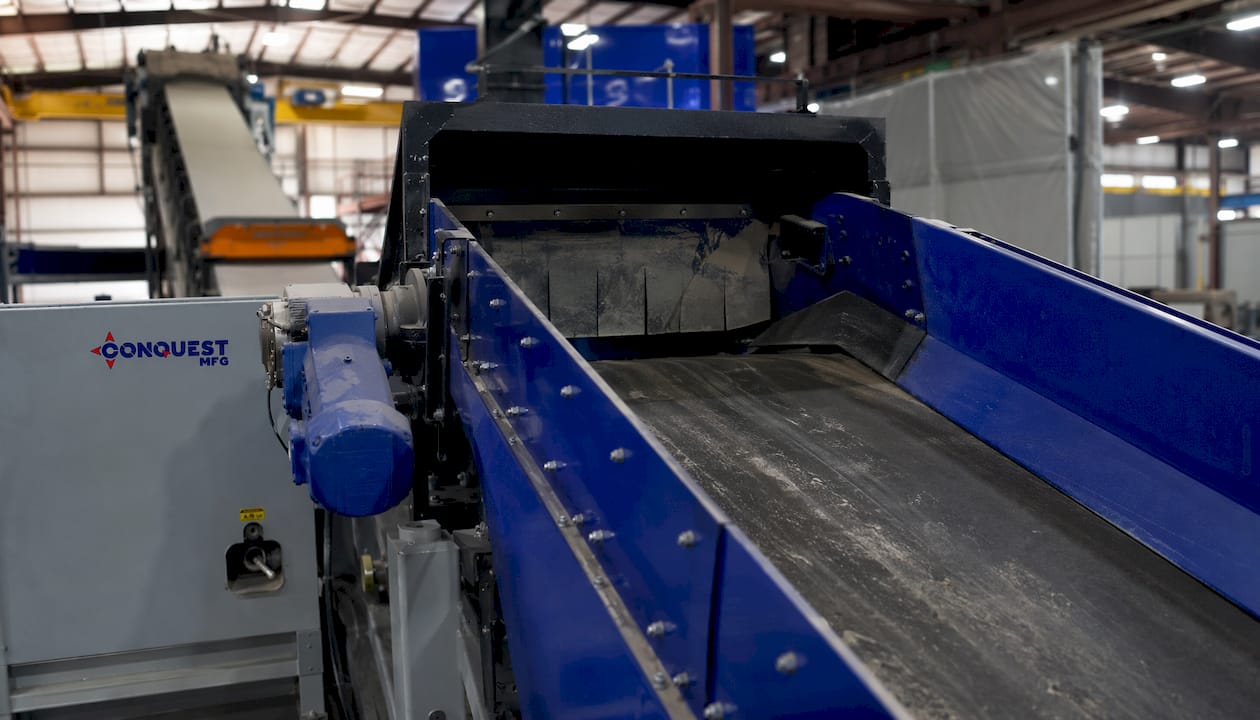 Close-up industrial conveyor with brand logo