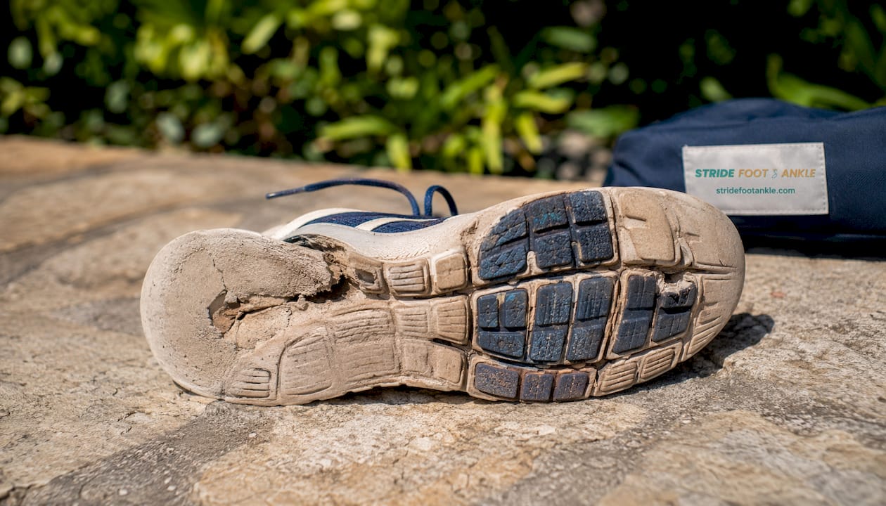 Worn athletic shoe sole with branded shoebox