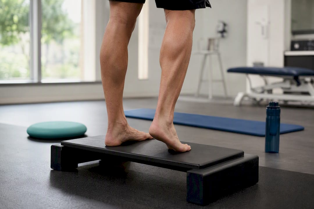 Foot performing eccentric calf lowering exercise