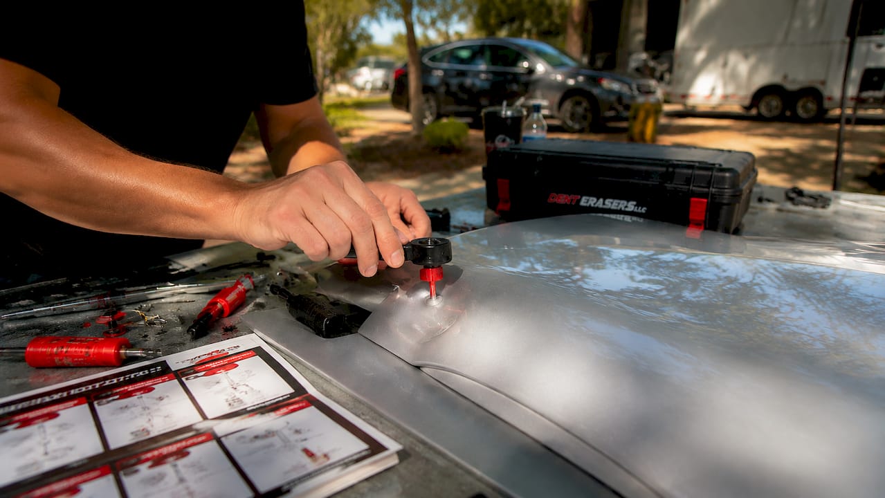 Plan Dent Repair on a Budget: Your 2026 Cost Guide 1 Hands Assembling Diy Dent Repair Kit In Garage