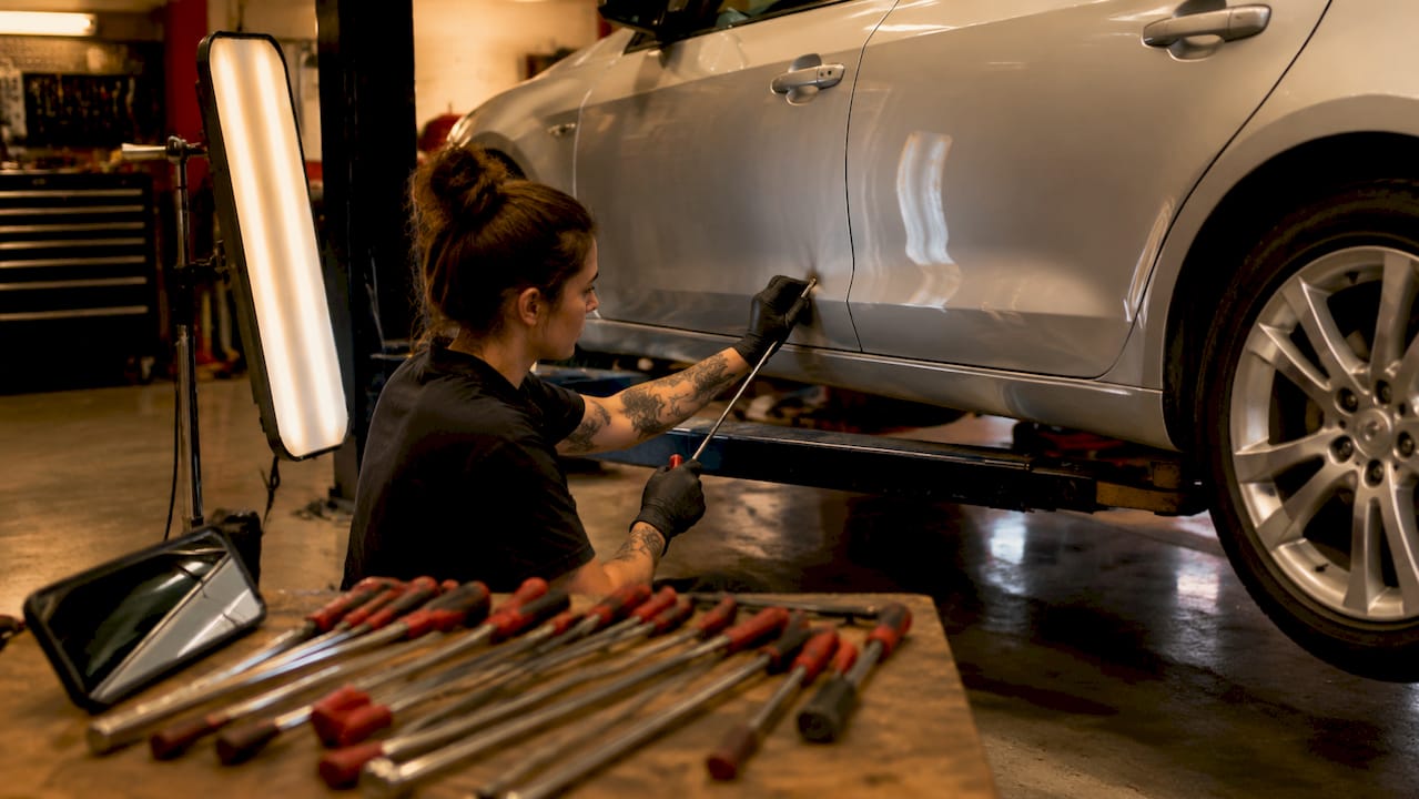 Car Dent Location Types: What Owners Need to Know 1 Technician Repairing Flat Door Panel Dent