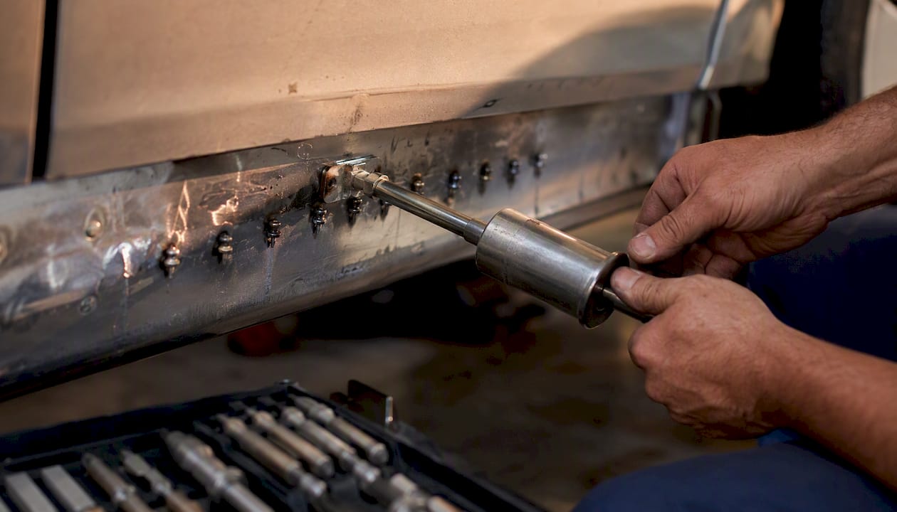 Rocker Panel Dent Repair Options for Car Owners 2 Hands Using Slide Hammer On Stud-Welded Dent