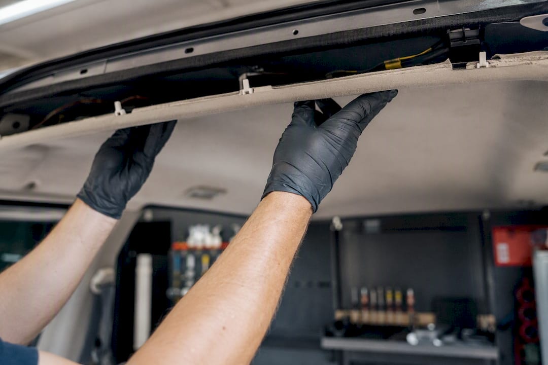 Roof Dent Repair PDR: What Works and When to Walk Away 1 Hands Lowering Car Headliner For Roof Access