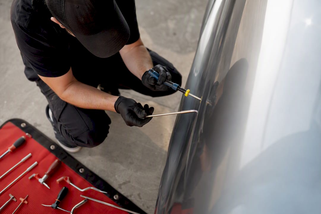 Car Owners: Five Factor Inspection Checklist for Body Line Dent Repair 1 Hands Pushing Dent Metal During Staged Repair