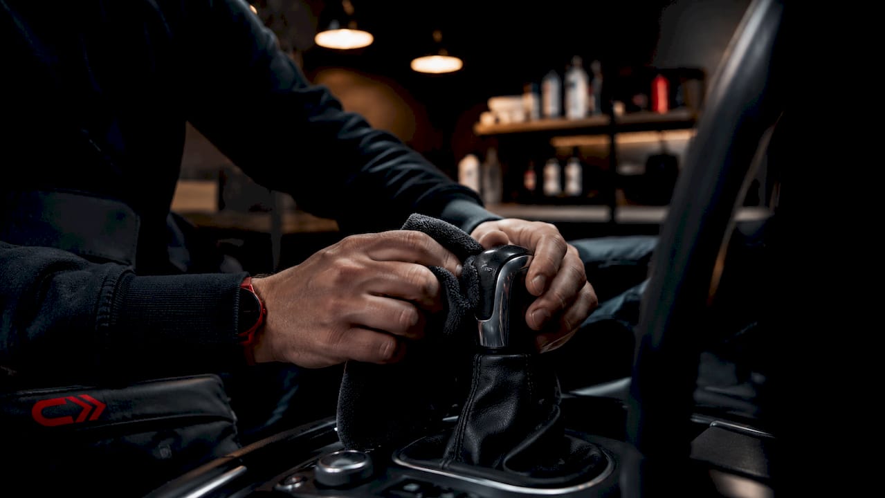 Close-up of hands polishing car steering wheel