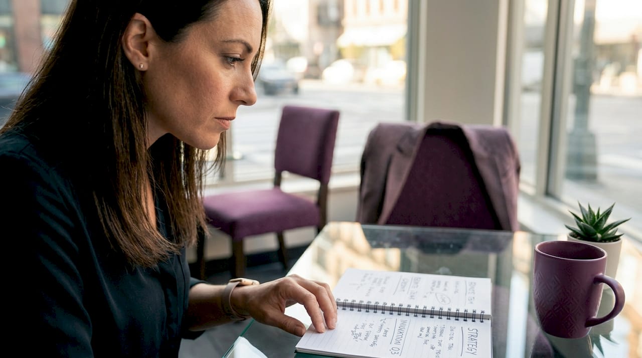 Entrepreneur working in bright corner office