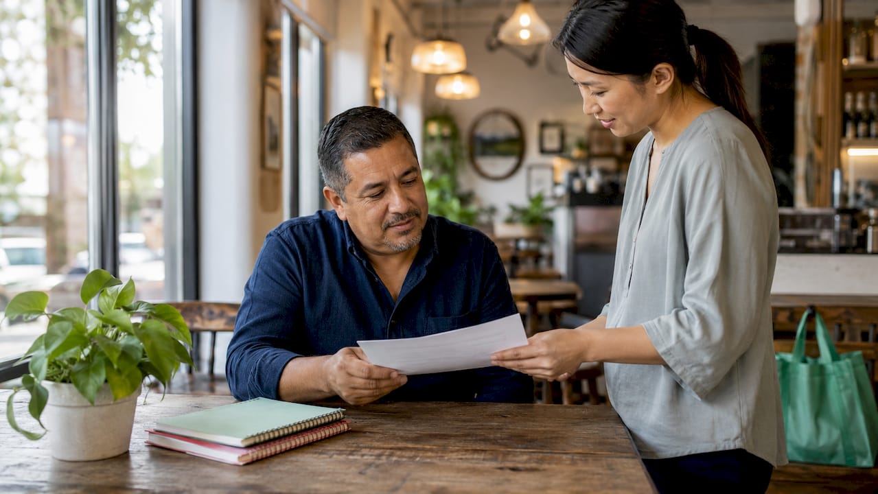 Hands exchanging employment certification form
