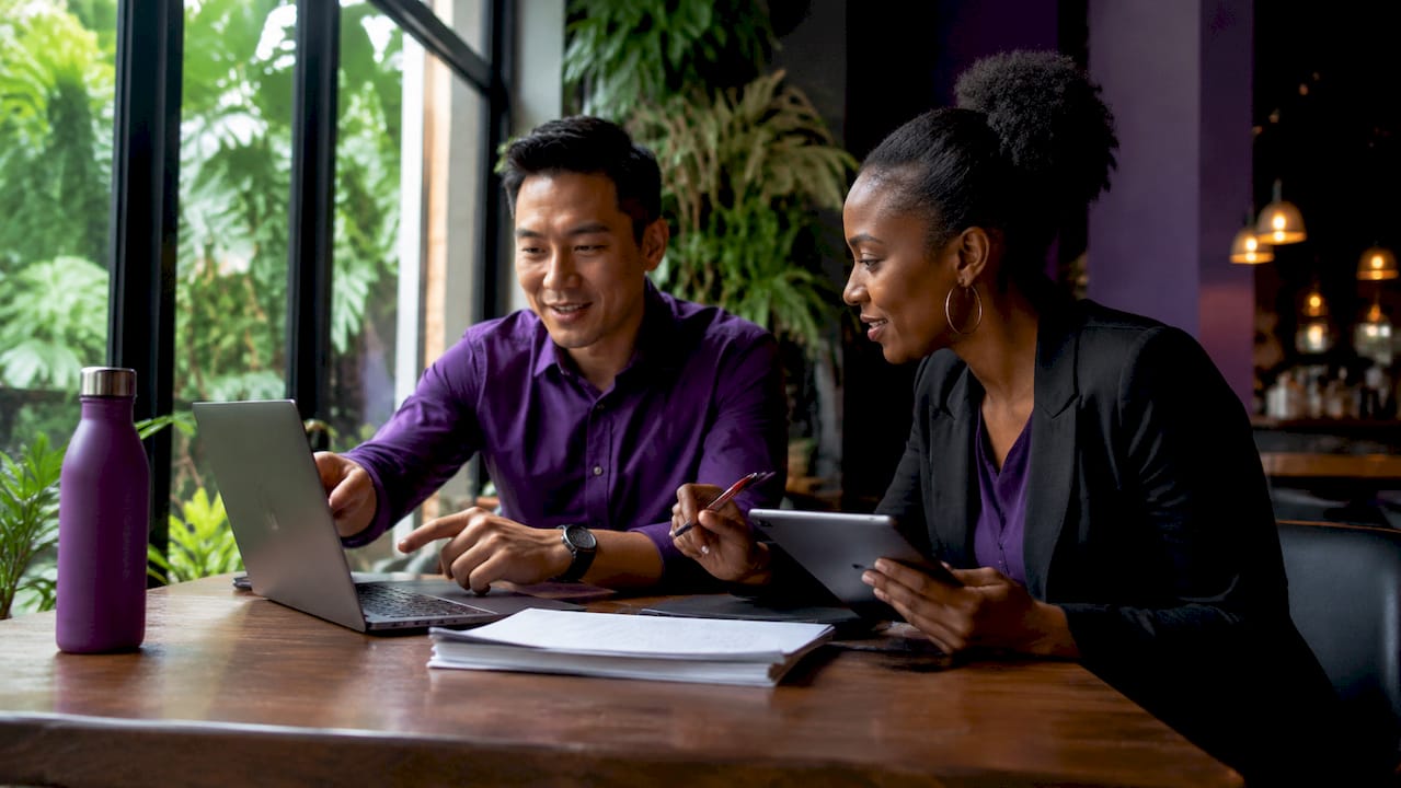 Two professionals planning virtual assistant tasks