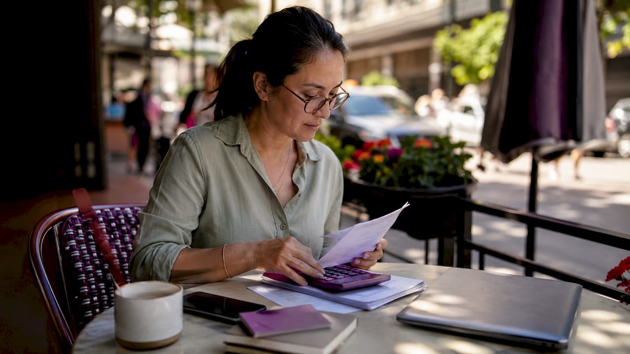 Entrepreneur reviewing virtual assistant costs at home