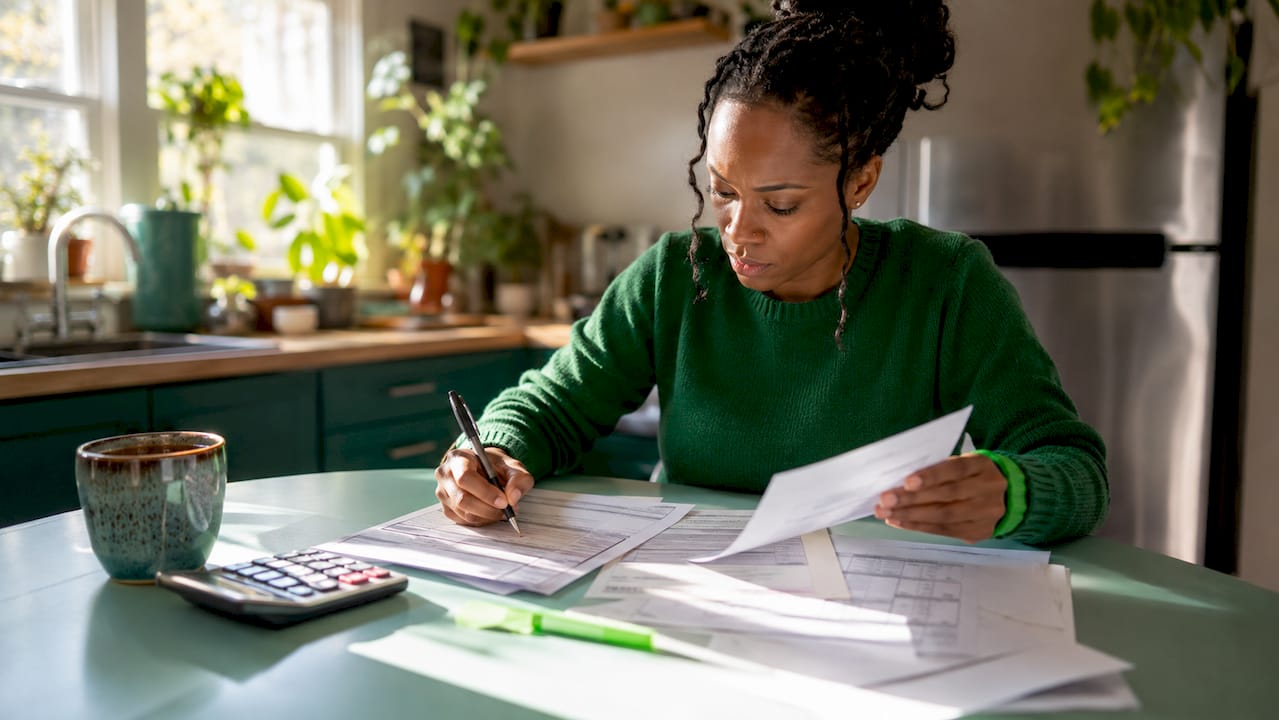 Woman completing federal student loan forms at home desk