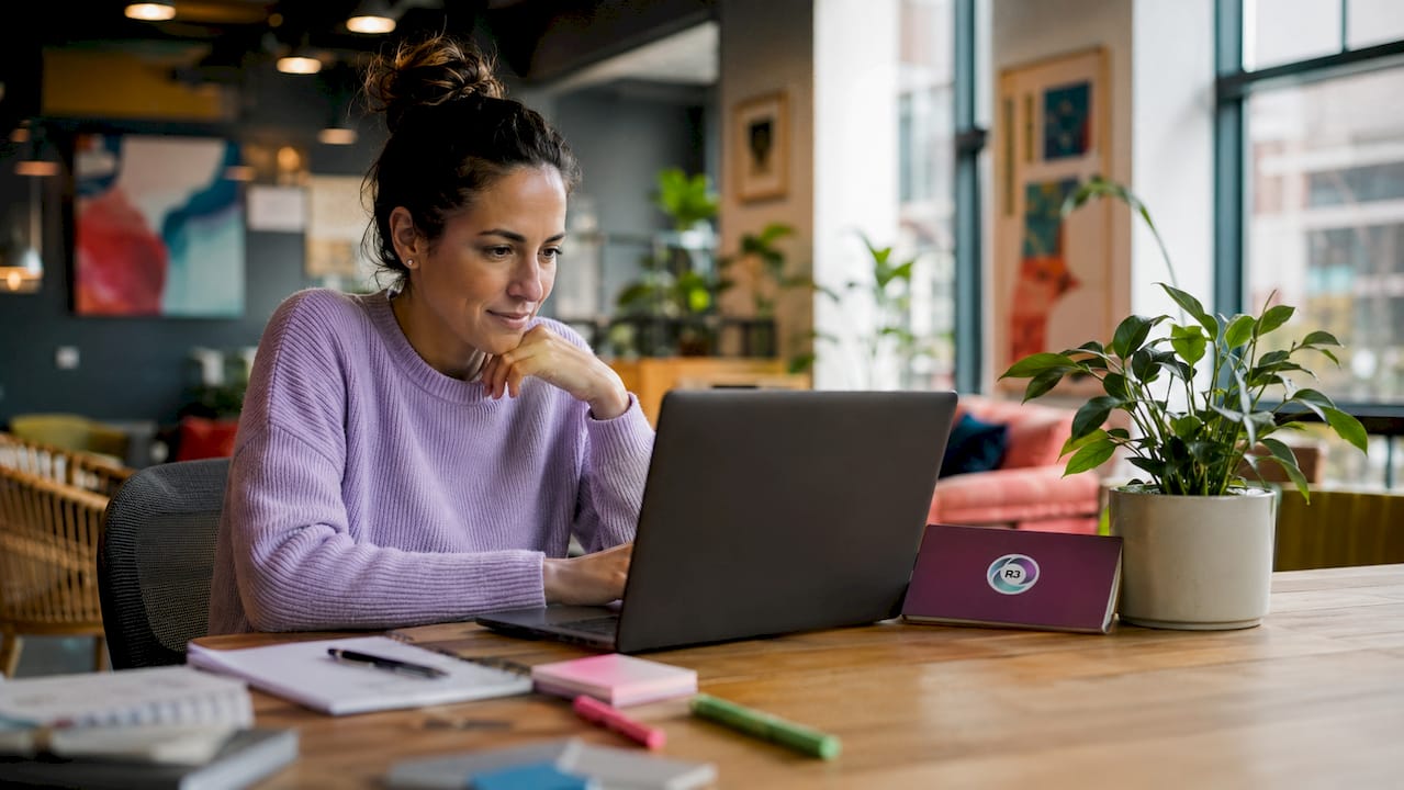 Businesswoman video calling virtual assistant at home desk