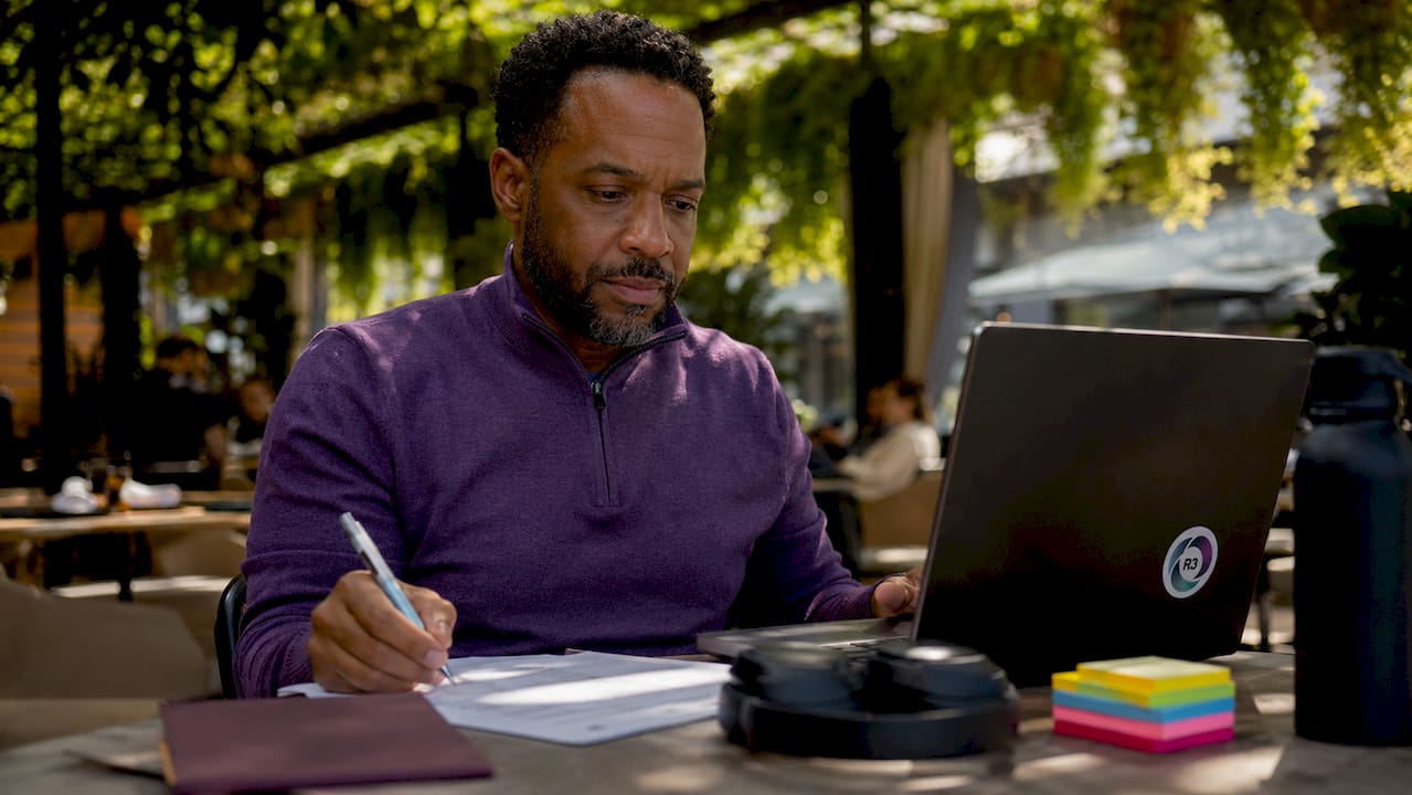 Man organizing emails at coworking desk