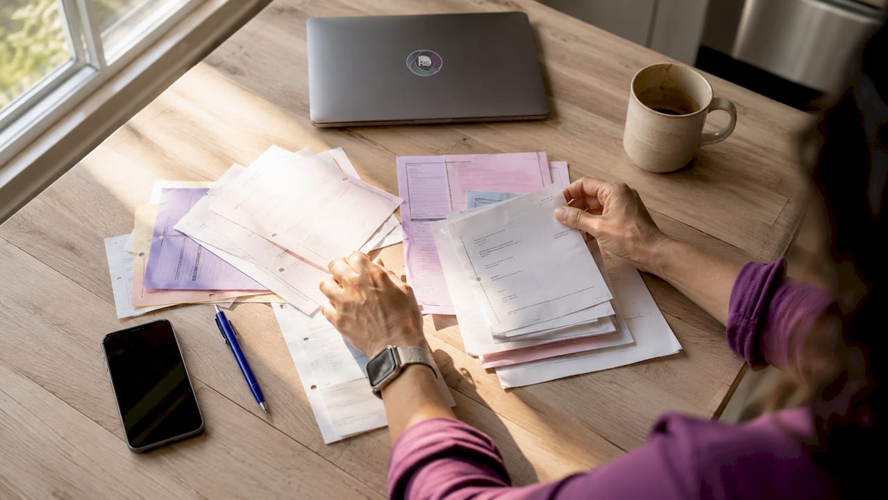 Close-up hands sorting recruitment fee papers