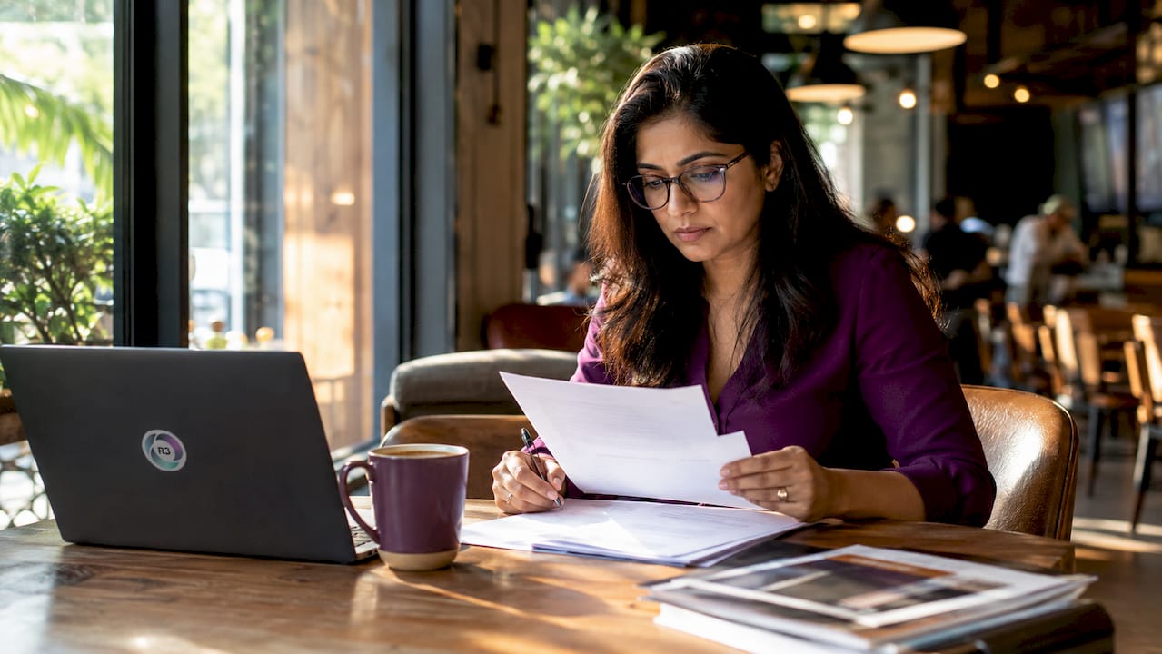 Entrepreneur reviewing hiring documents at desk