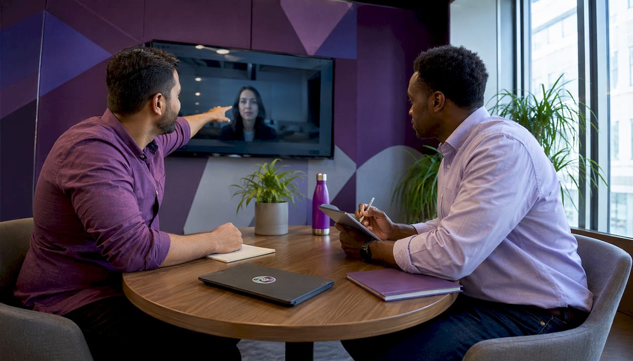 Two men collaborating on remote team plans